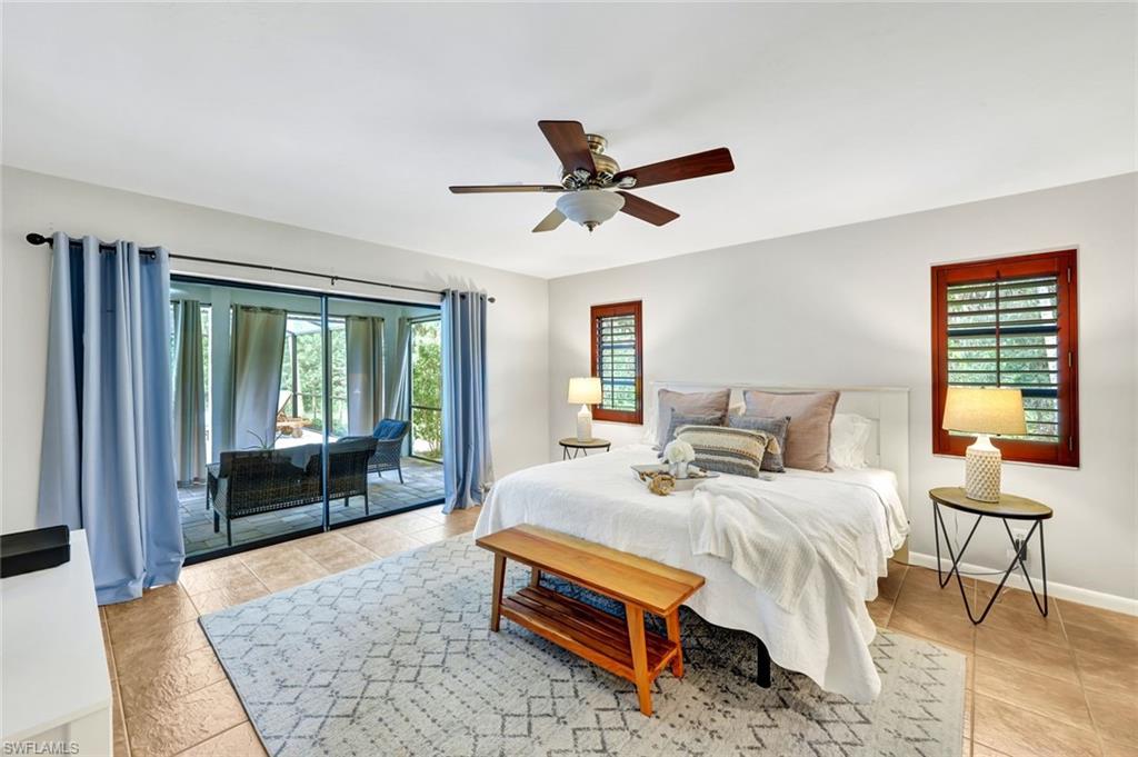 4530 13th Avenue Southwest Naples, FL 34116 - Photo 15 of 30 a bedroom with a bed and a large window
