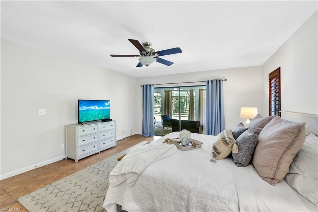 4530 13th Avenue Southwest Naples, FL 34116 - Photo 16 of 30 a bedroom with a bed and a flat screen tv