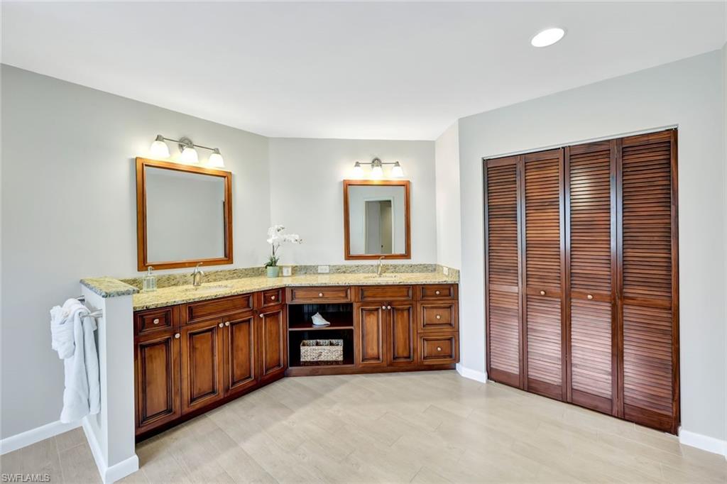 4530 13th Avenue Southwest Naples, FL 34116 - Photo 17 of 30 a spacious bathroom with a granite countertop sink and mirror