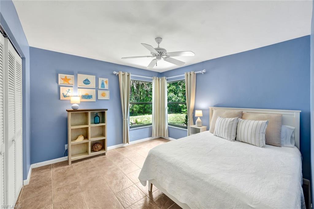 4530 13th Avenue Southwest Naples, FL 34116 - Photo 21 of 30 a bedroom with a large bed and a large window