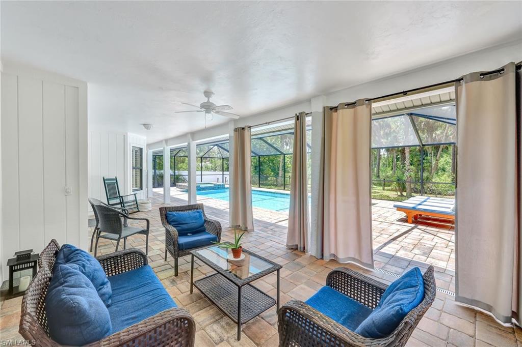 4530 13th Avenue Southwest Naples, FL 34116 - Photo 24 of 30 a living room with furniture and a floor to ceiling window