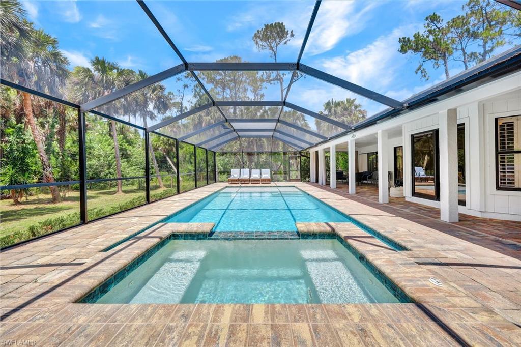 4530 13th Avenue Southwest Naples, FL 34116 - Photo 3 of 30 a view of swimming pool with a lounge chairs in patio