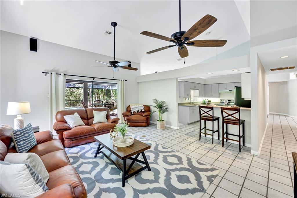 4530 13th Avenue Southwest Naples, FL 34116 - Photo 4 of 30 a living room with furniture a window and a ceiling fan