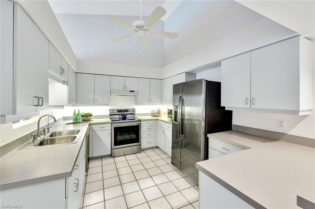 4530 13th Avenue Southwest Naples, FL 34116 - Photo 7 of 30 a kitchen with a sink cabinets and stainless steel appliances