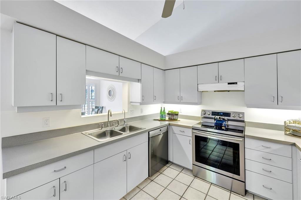 4530 13th Avenue Southwest Naples, FL 34116 - Photo 8 of 30 a kitchen with granite countertop white cabinets and white appliances