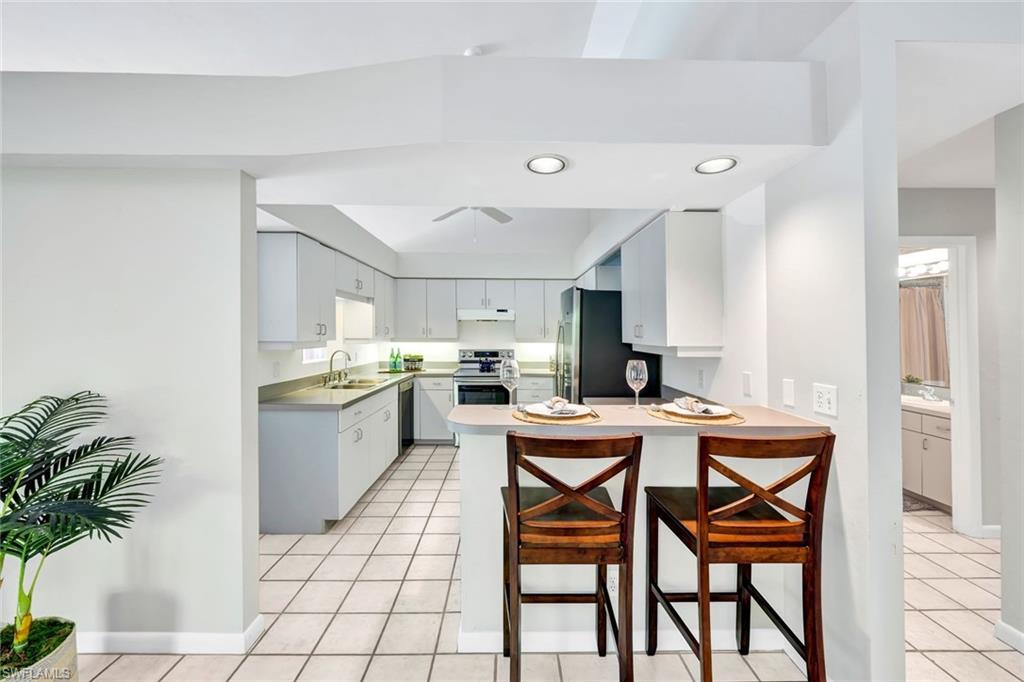 4530 13th Avenue Southwest Naples, FL 34116 - Photo 9 of 30 a kitchen with a table and chairs in it