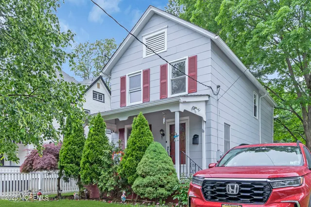 a view of a house with brick walls and potted plants