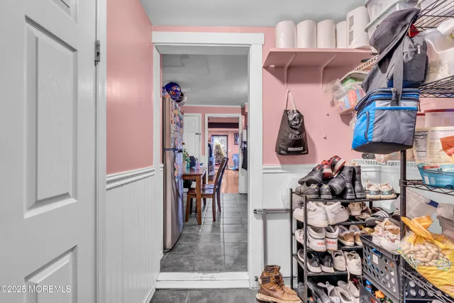 a view of a hallway with dining area and chandelier