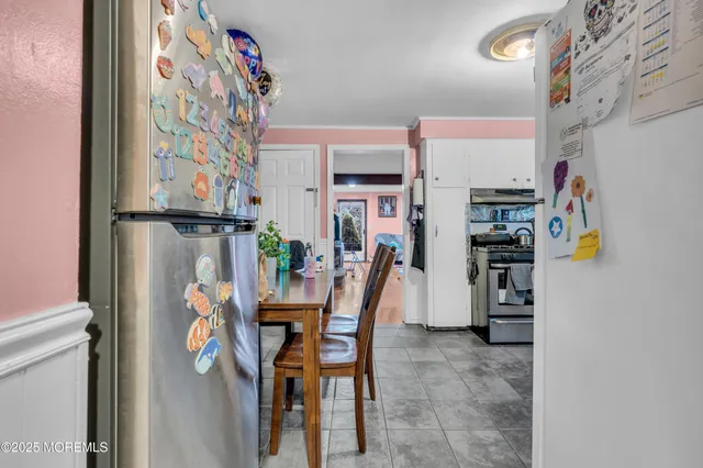 a dining room with furniture and a kitchen view