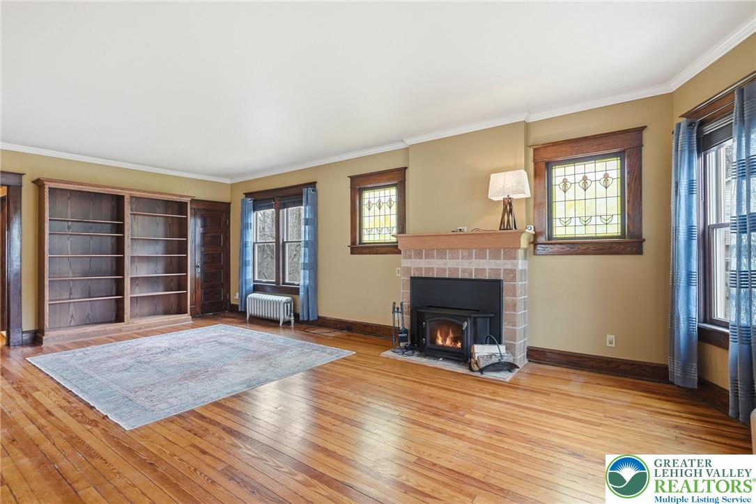 802 Poplar Street Clarks Summit, PA 18411 - Photo 12 of 50 a view of an empty room with wooden floor fireplace and a window
