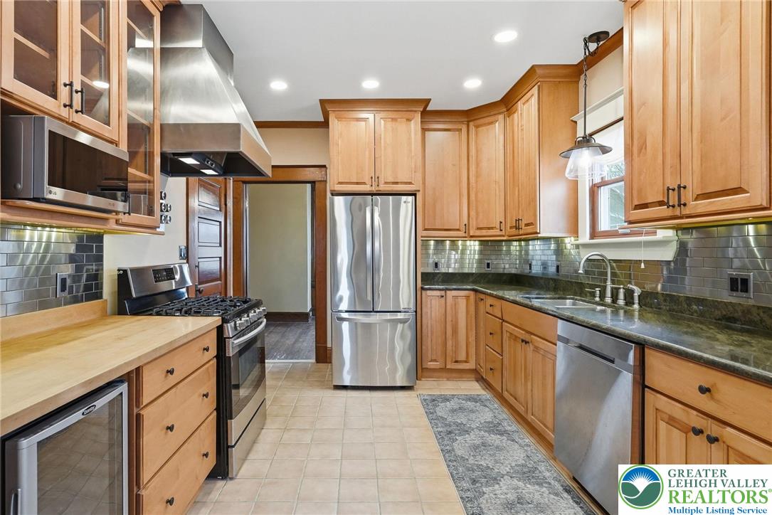 802 Poplar Street Clarks Summit, PA 18411 - Photo 17 of 50 a kitchen with stainless steel appliances granite countertop a sink a stove and a refrigerator