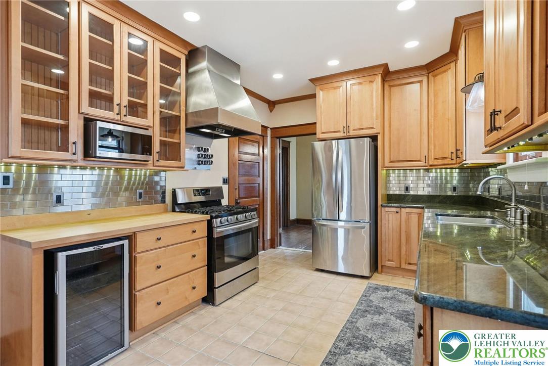 802 Poplar Street Clarks Summit, PA 18411 - Photo 18 of 50 a kitchen with stainless steel appliances granite countertop a refrigerator a stove and a sink