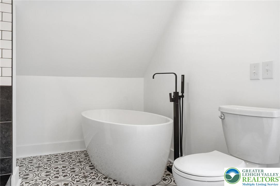 802 Poplar Street Clarks Summit, PA 18411 - Photo 29 of 50 a white toilet sitting next to a shower