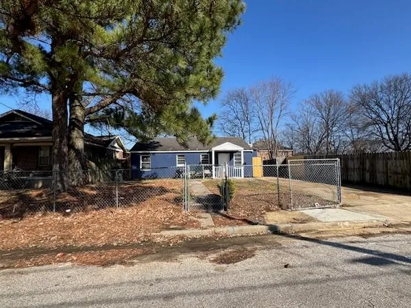 a front view of a house with a yard covered with snow
