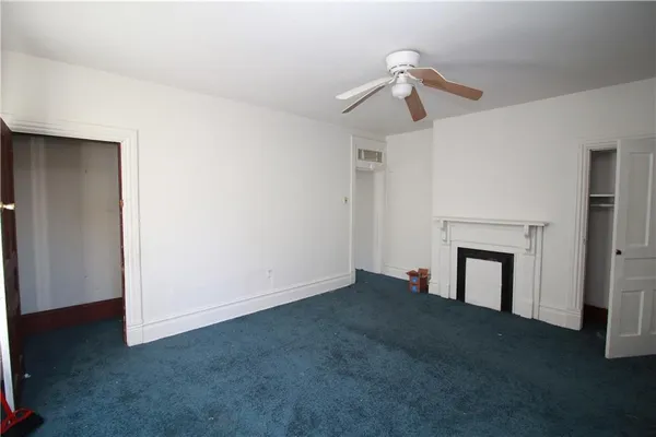 a view of empty room with fireplace
