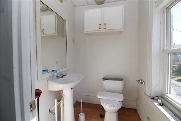 a bathroom with a sink toilet and a mirror