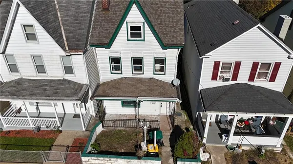 a view of a white house with large windows
