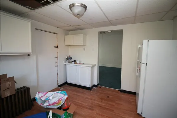 a view of a room with wooden floor and workspace