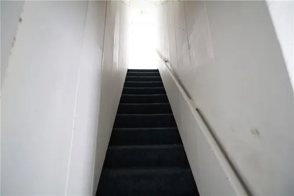 a view of a hallway with wooden floor and entryway