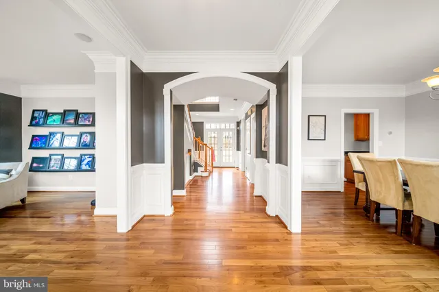 a view of a living room with furniture and wooden floor