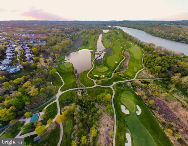a picture of a wall with a bench and a potted plant