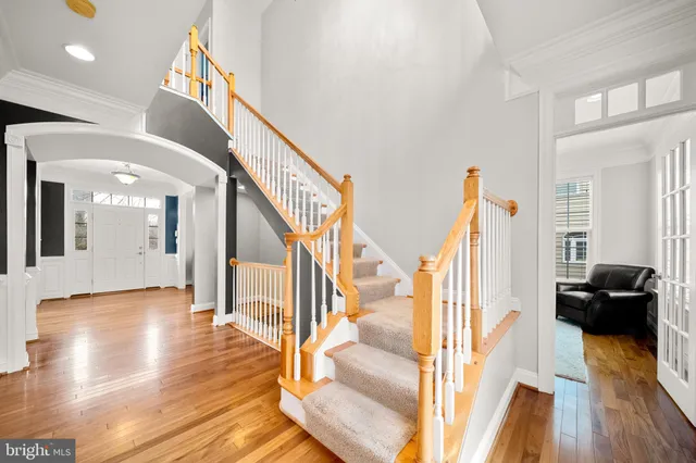 a view of a livingroom with wooden floor and stairs