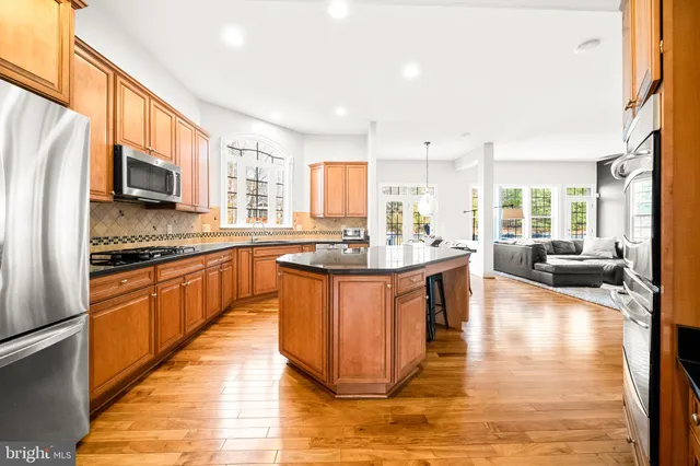 a large kitchen with stainless steel appliances granite countertop a large counter top stainless steel appliances and cabinets