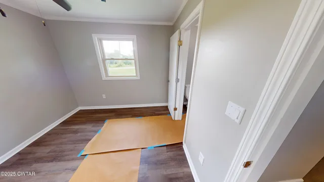 a view of a room with wooden floor and staircase