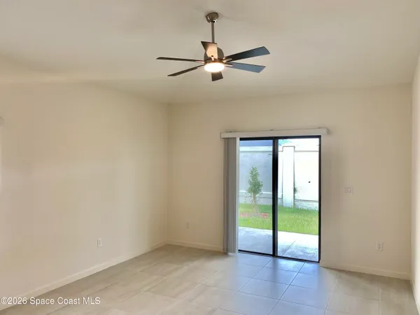 a view of an empty room with a fan