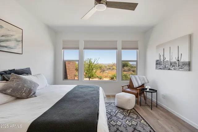 a bedroom with furniture and a large window