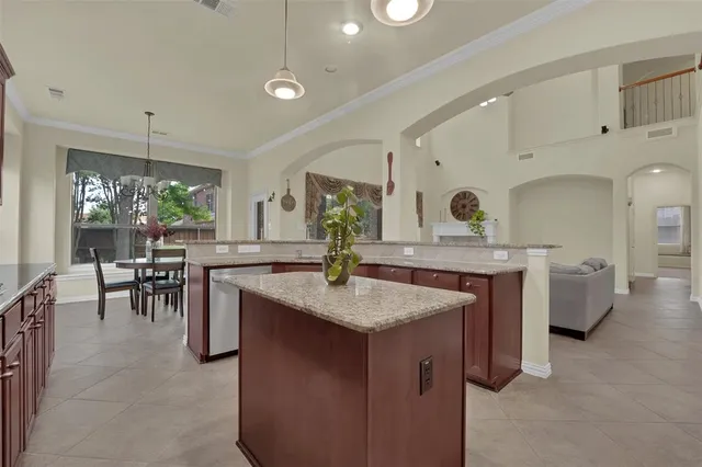 a kitchen with center island table and chairs in it