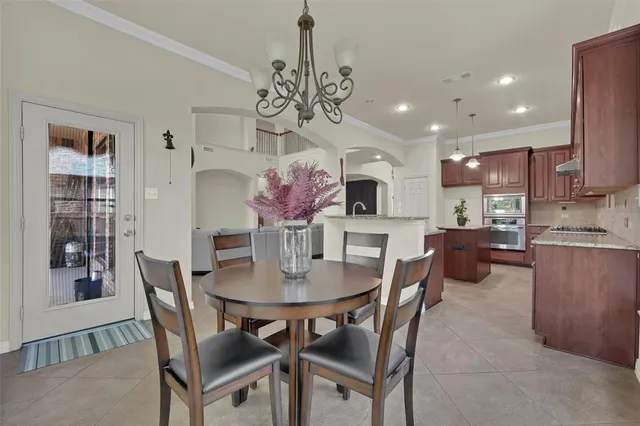a view of a dining room with furniture and a chandelier