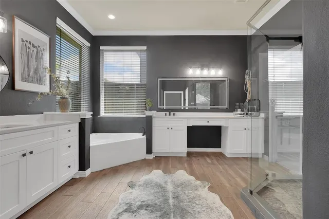 a spacious bathroom with a bathtub sink and mirror