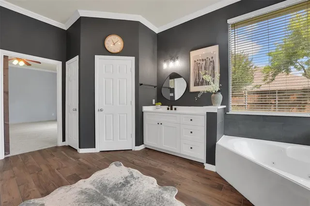 a spacious bathroom with a bathtub a mirror a sinks and a shower