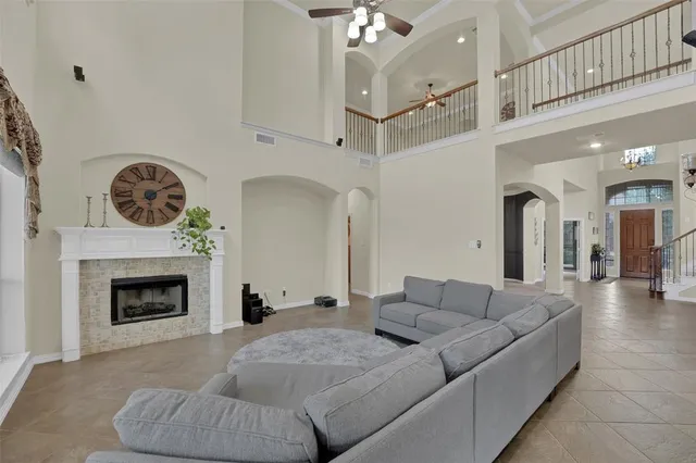 a living room with furniture a fireplace and a chandelier