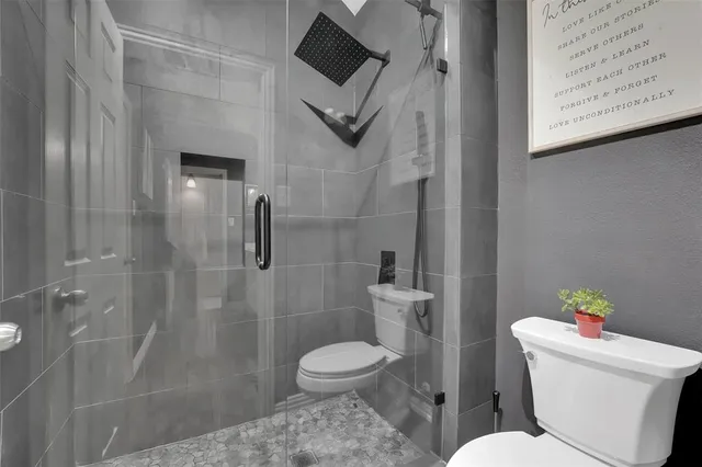 a bathroom with a toilet and a shower