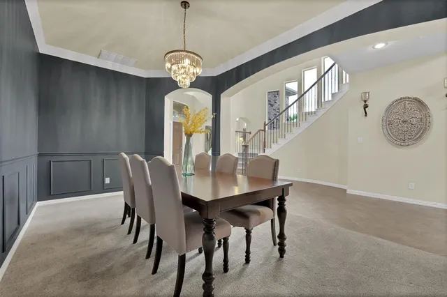 a view of a dining room and chandelier fan