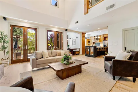 a living room with fireplace furniture and a large window