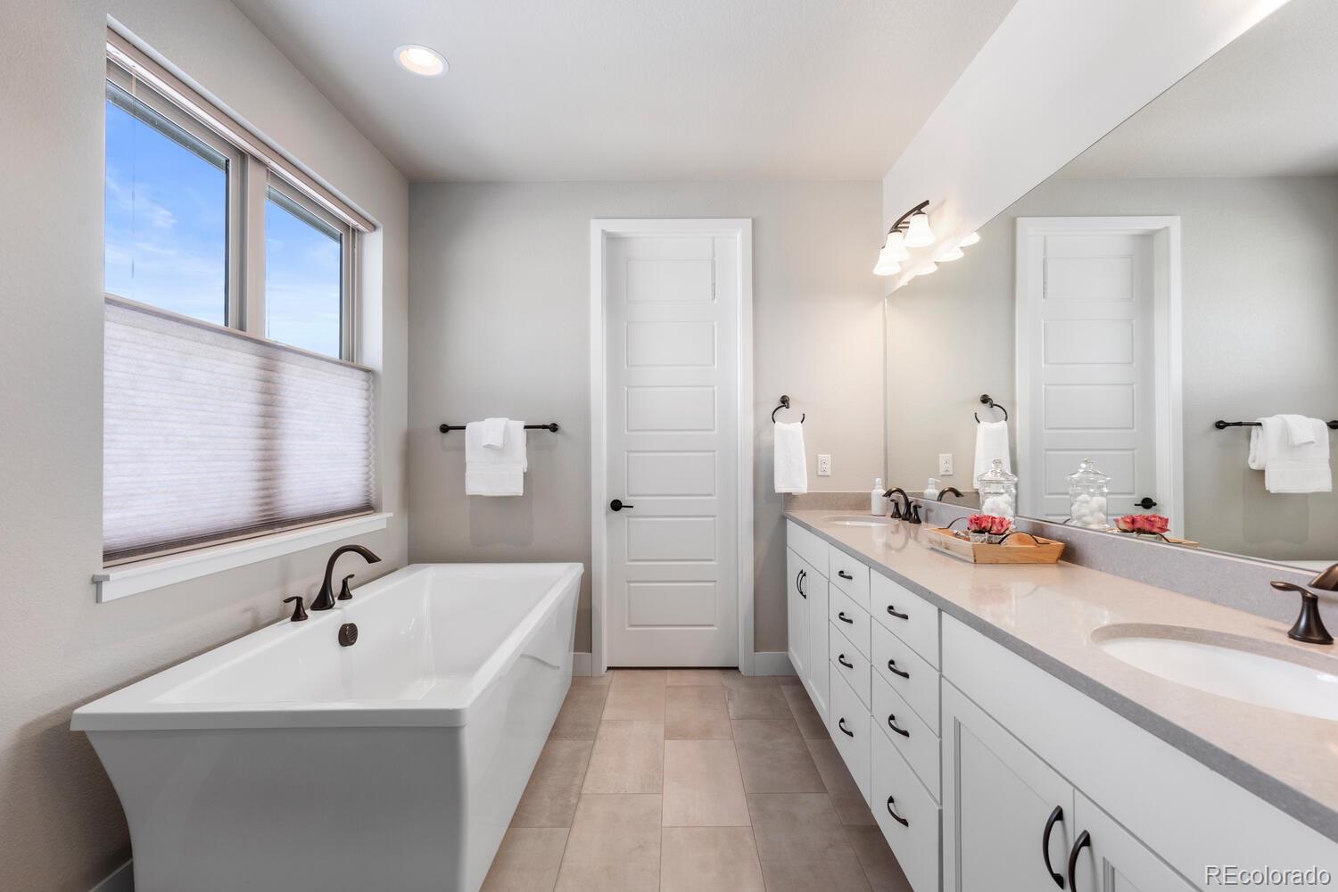 507 Red Thistle Drive Highlands Ranch, CO 80126 - Photo 20 of 42 a bathroom with a double vanity sink mirror and double