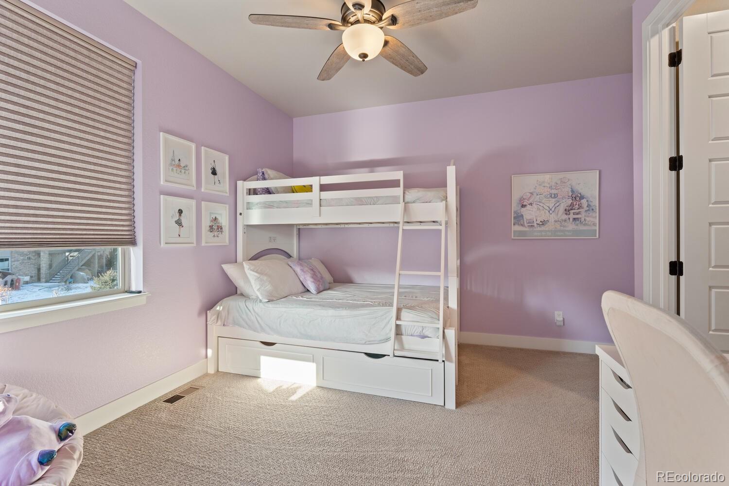 507 Red Thistle Drive Highlands Ranch, CO 80126 - Photo 21 of 42 a bedroom with furniture and chandelier