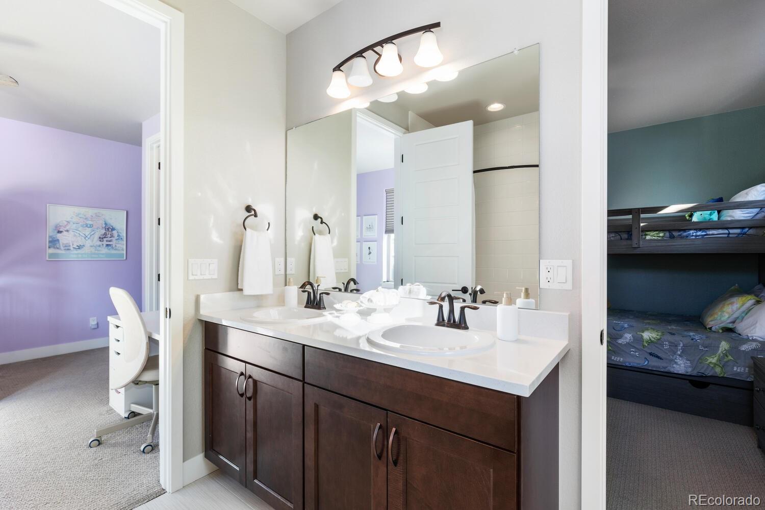 507 Red Thistle Drive Highlands Ranch, CO 80126 - Photo 23 of 42 a en suite bathroom with a sink double vanity and a mirror
