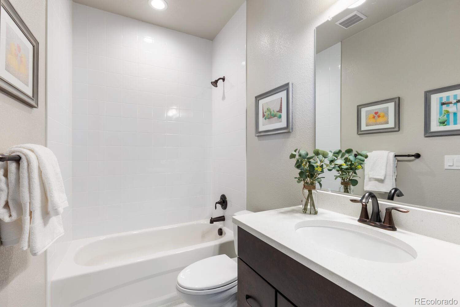 507 Red Thistle Drive Highlands Ranch, CO 80126 - Photo 25 of 42 a bathroom with a granite countertop sink a toilet and shower