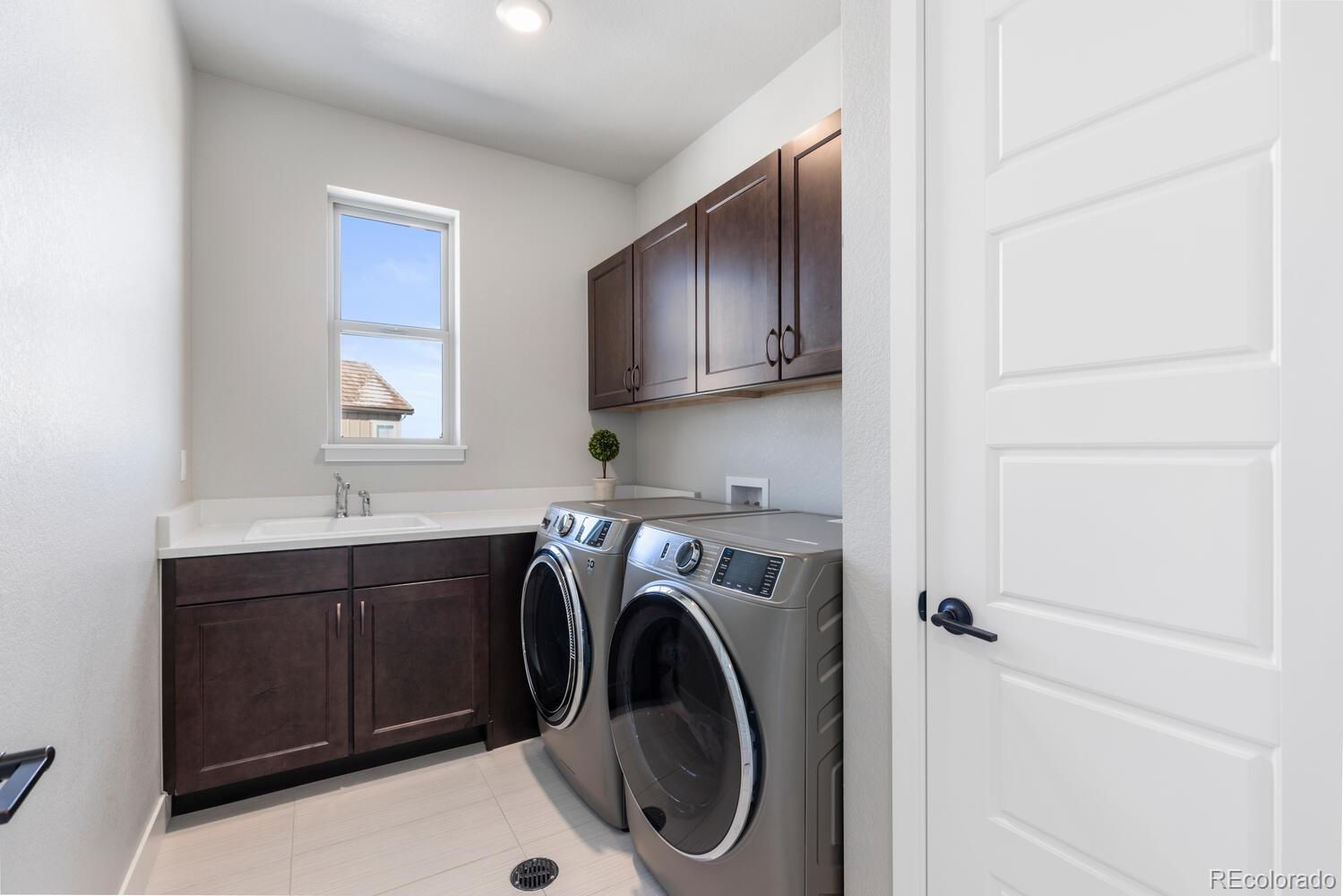 507 Red Thistle Drive Highlands Ranch, CO 80126 - Photo 26 of 42 a utility room with sink dryer and washer