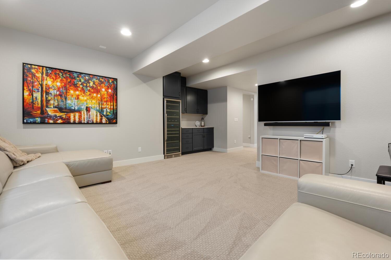 507 Red Thistle Drive Highlands Ranch, CO 80126 - Photo 28 of 42 a living room with furniture and a flat screen tv