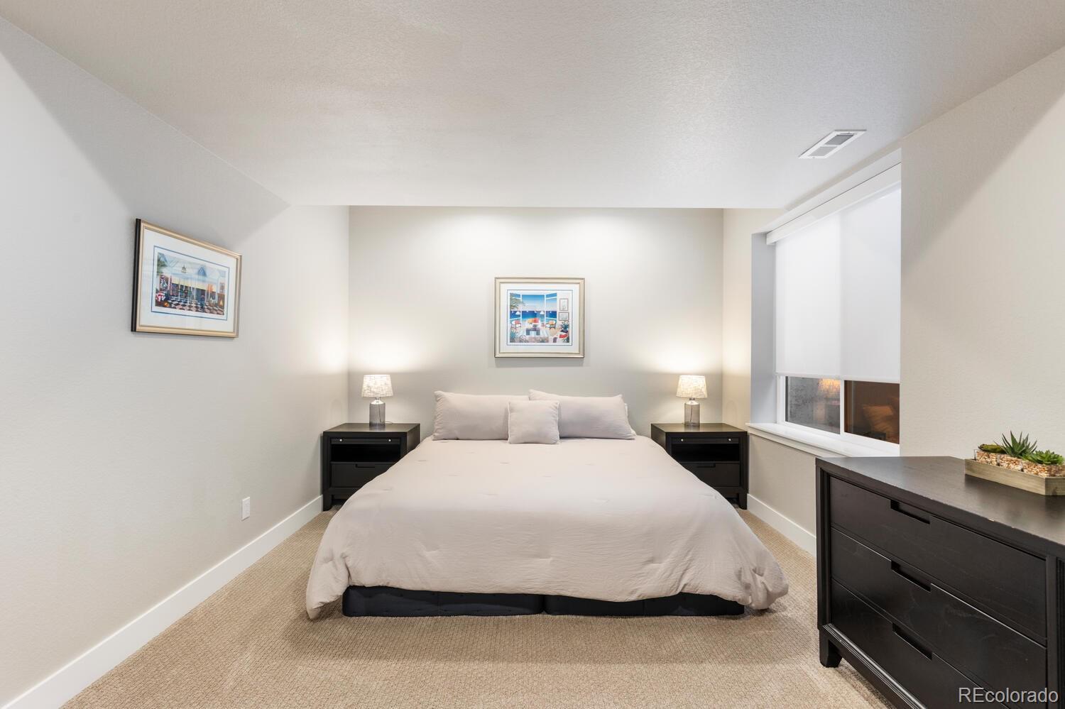 507 Red Thistle Drive Highlands Ranch, CO 80126 - Photo 30 of 42 a bedroom with a bed and a night stand