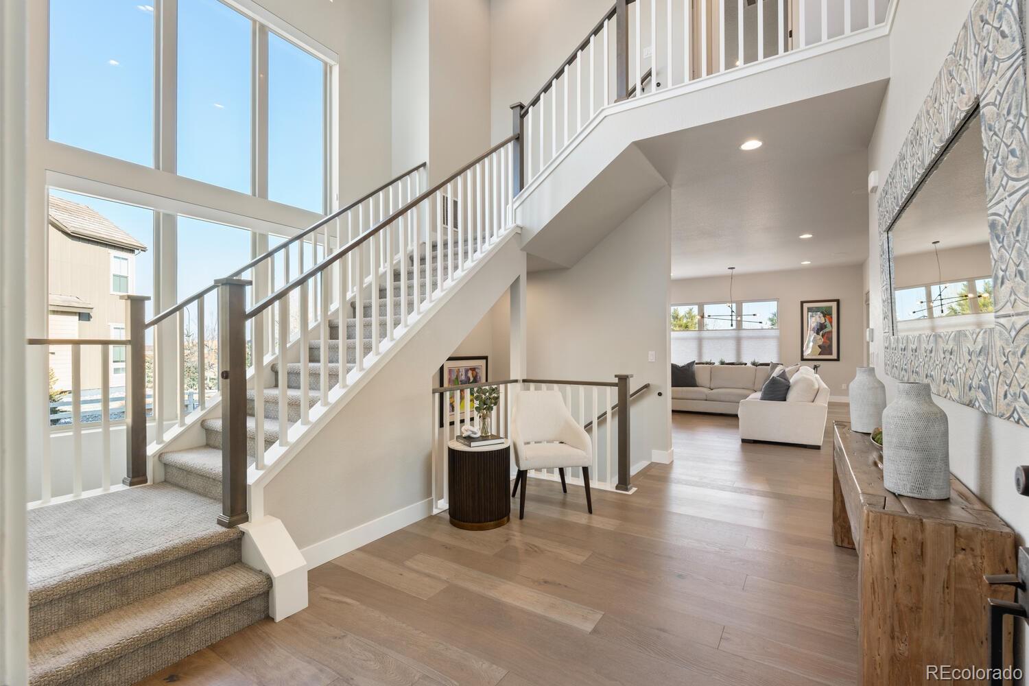 507 Red Thistle Drive Highlands Ranch, CO 80126 - Photo 3 of 42 a view of entryway and hall with wooden floor