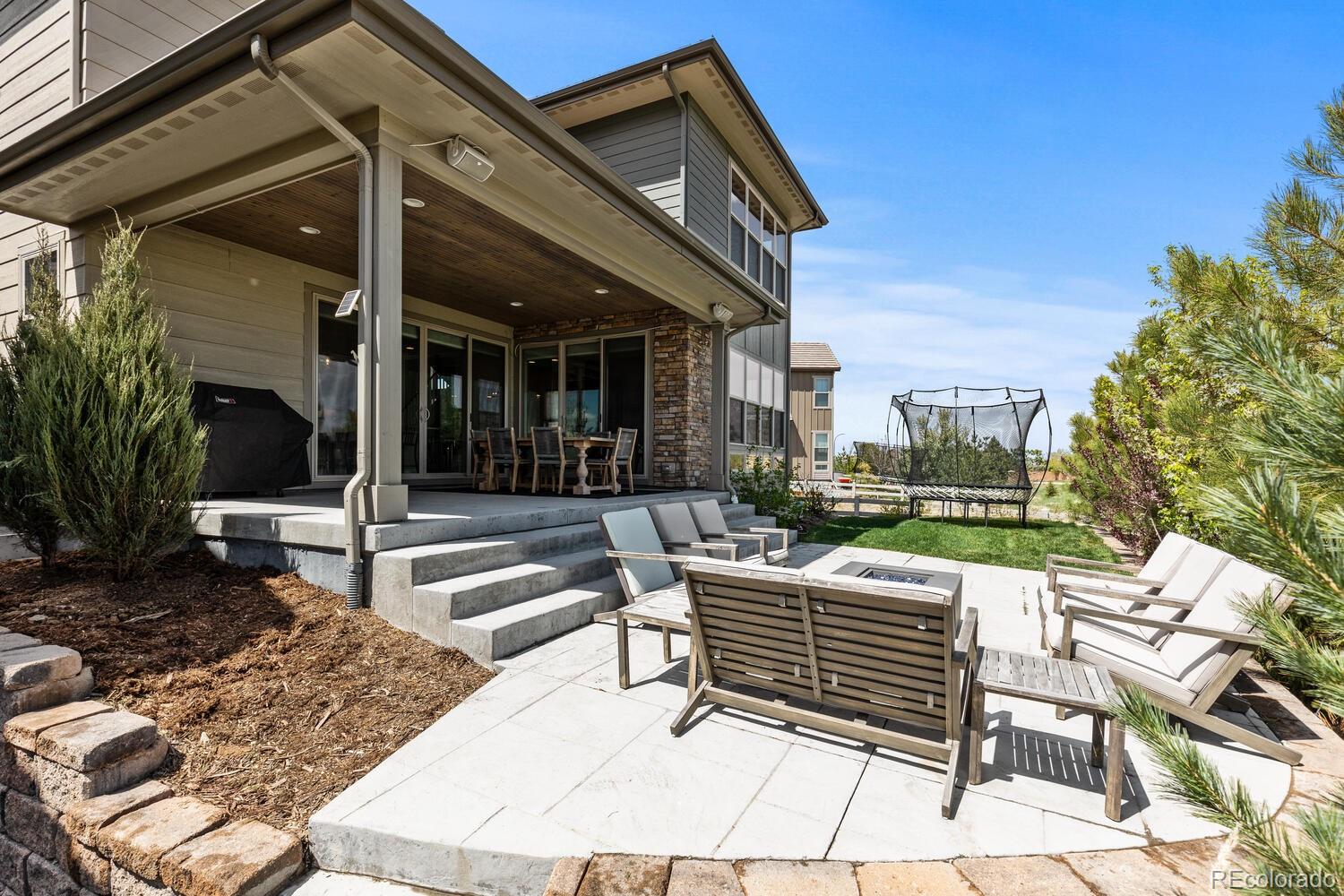 507 Red Thistle Drive Highlands Ranch, CO 80126 - Photo 32 of 42 a view of a patio with a table and chairs and potted plants