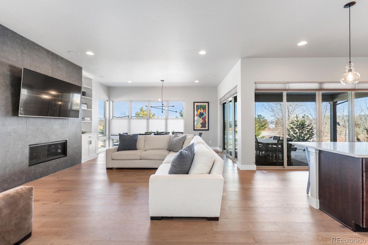 507 Red Thistle Drive Highlands Ranch, CO 80126 - Photo 4 of 42 a living room with fireplace furniture and a flat screen tv