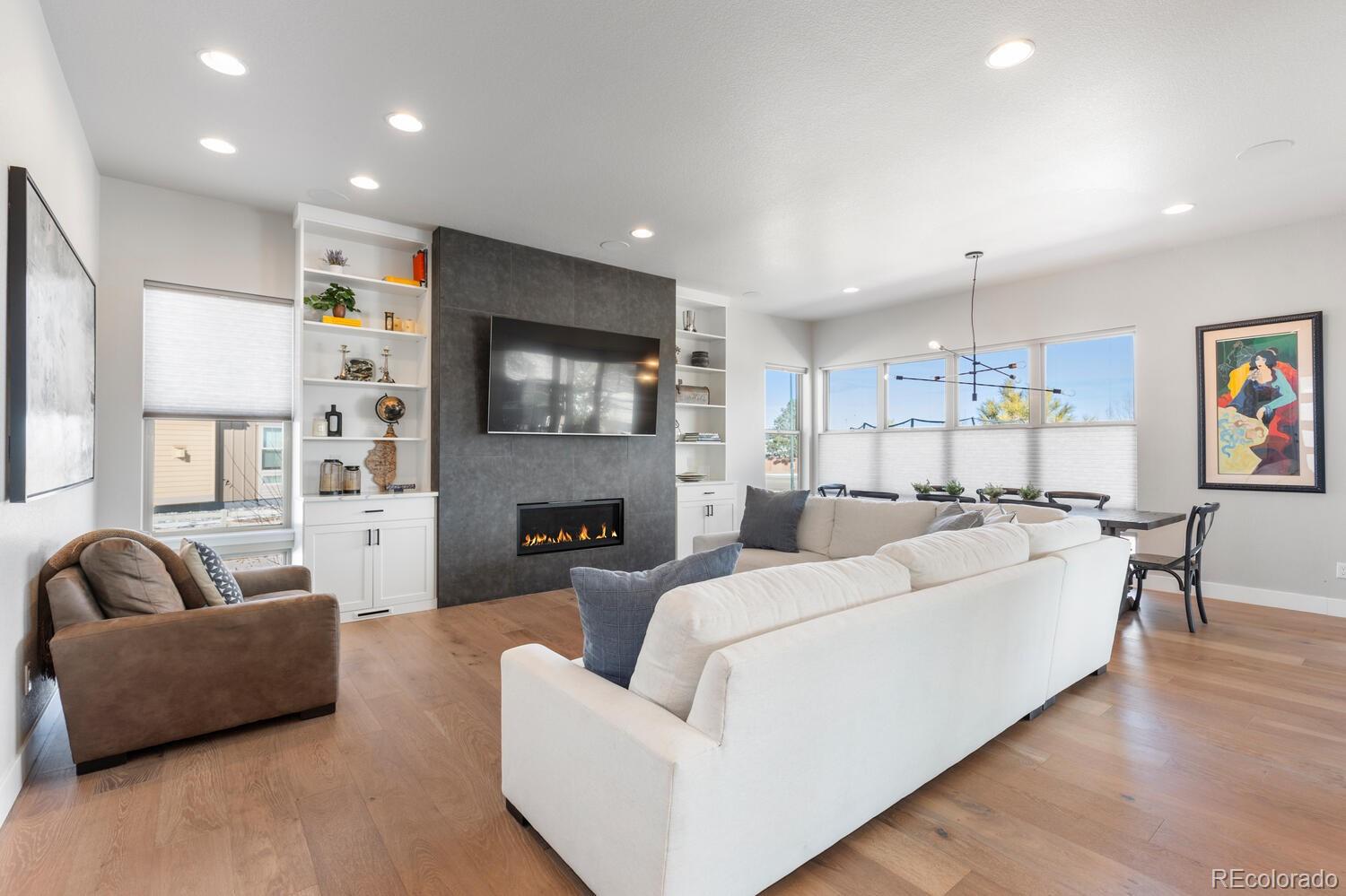 507 Red Thistle Drive Highlands Ranch, CO 80126 - Photo 5 of 42 a living room with furniture kitchen view and a flat screen tv