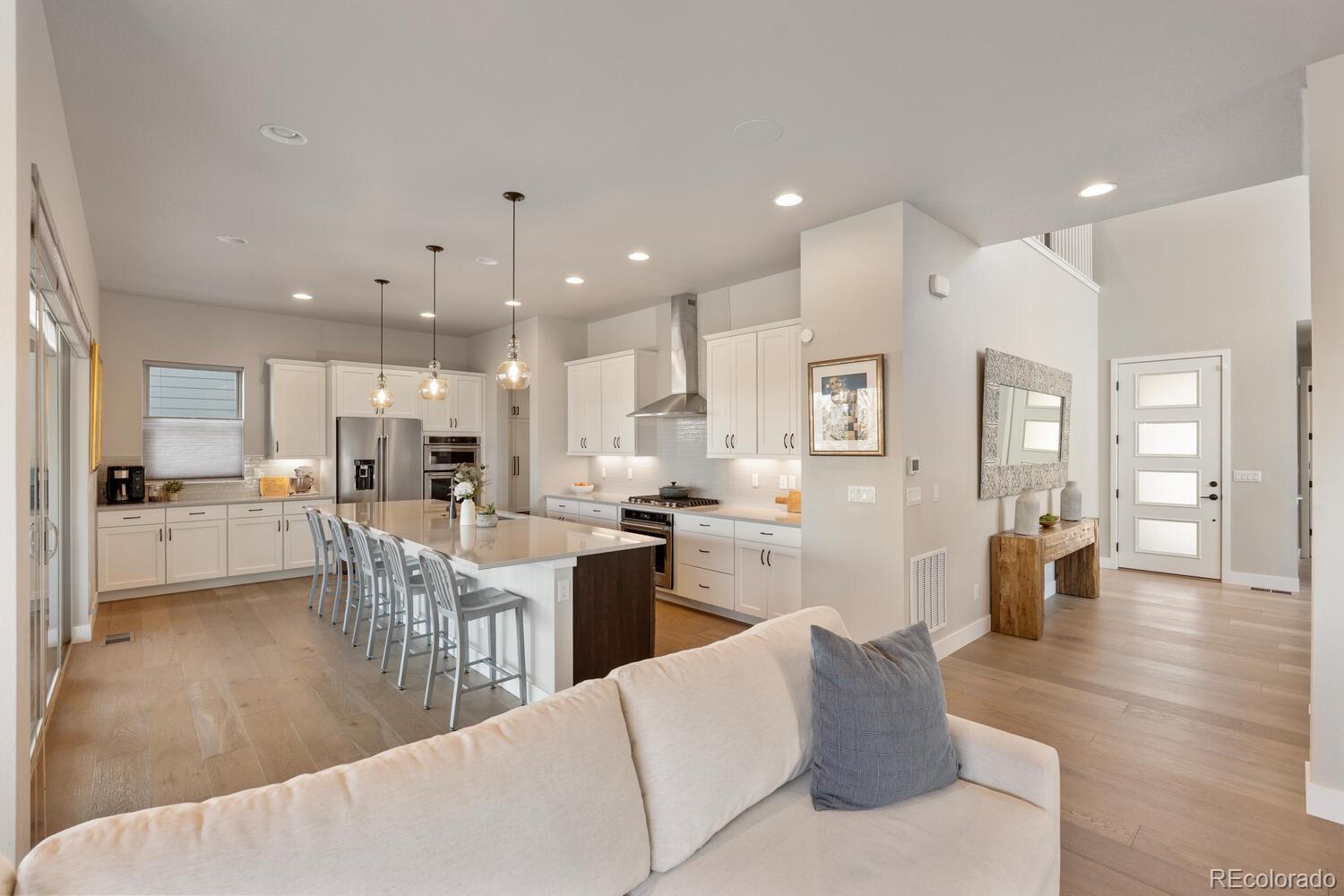 507 Red Thistle Drive Highlands Ranch, CO 80126 - Photo 7 of 42 a living room with kitchen island furniture and a view of kitchen